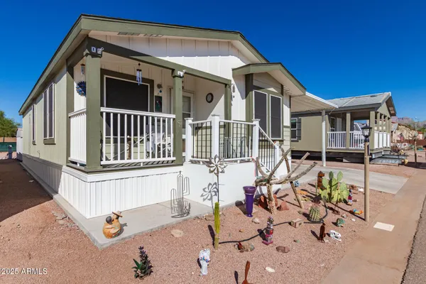 a front view of a house with sitting area