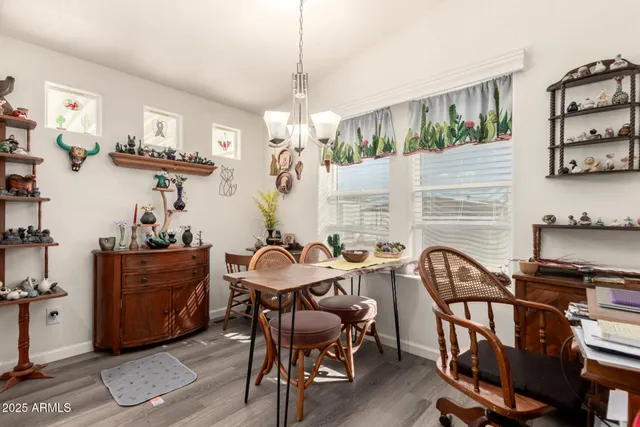 a view of a dining room with furniture and chandelier