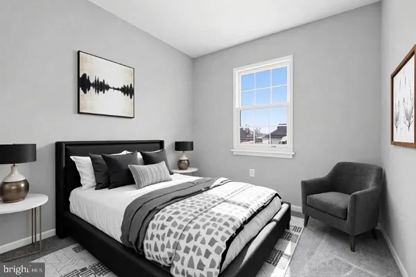 a bedroom with bed couch and window