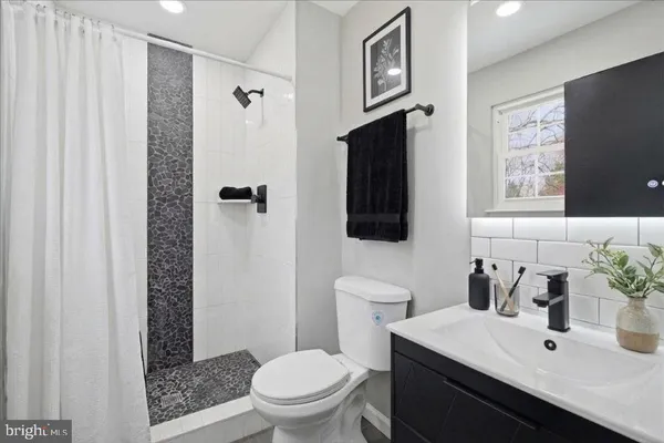 a bathroom with a sink toilet and shower