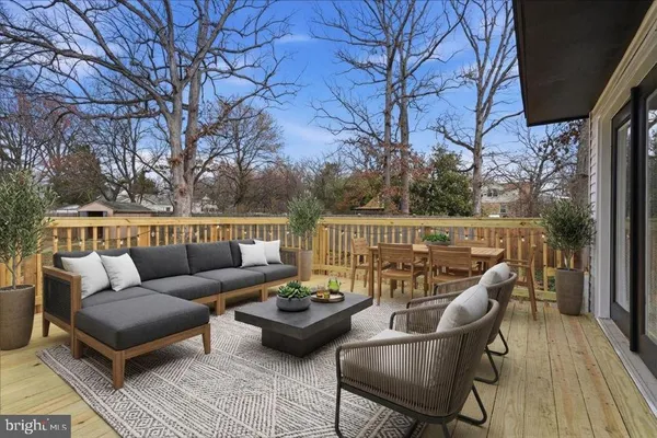 a view of a patio with couches table and chairs and potted plants