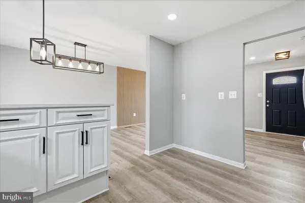 a view of an empty room with closet and wooden floor