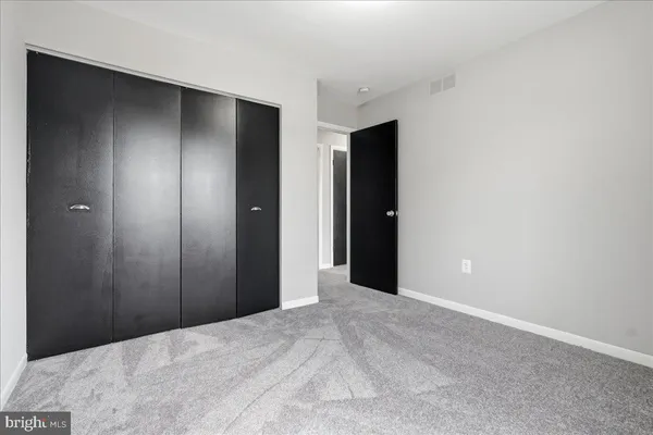 a view of an empty room with a ceiling fan