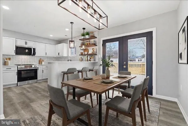 a view of a dining room with furniture and a kitchen