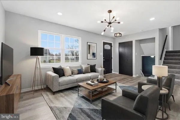 a living room with furniture a large window and a flat screen tv