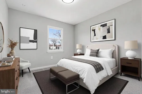 a bedroom with a bed and a lamp on table