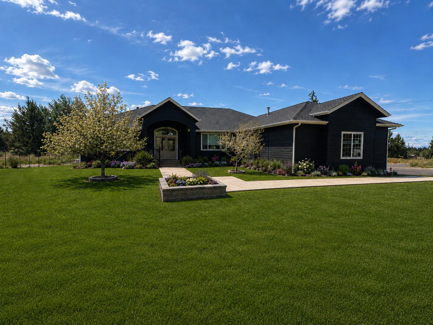 a front view of a house with garden and trees