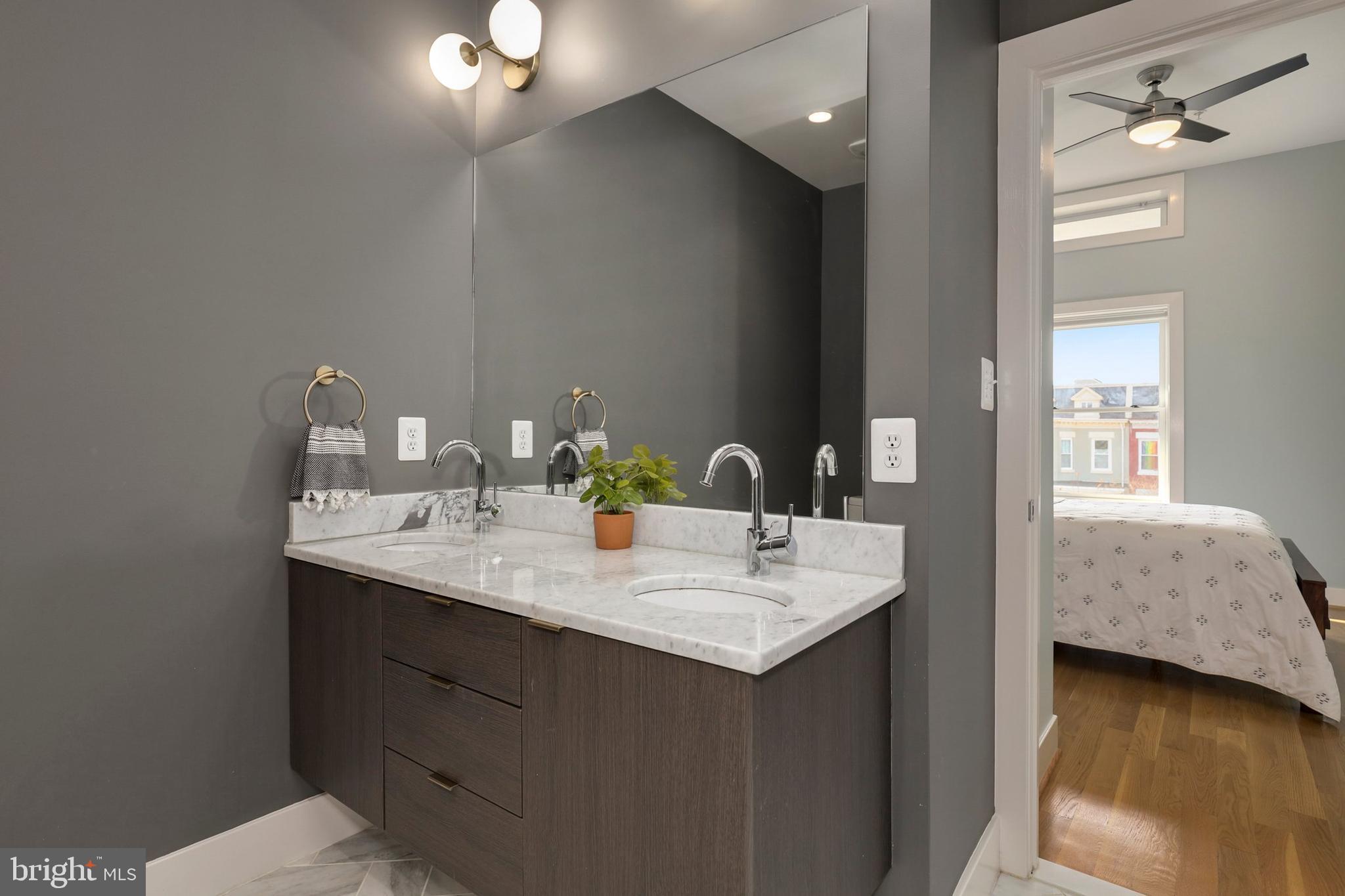 1337 Spring Road Northwest, Unit 3 Washington, DC 20010 - Photo 22 of 36 a en suite bathroom with a granite countertop sink and a mirror