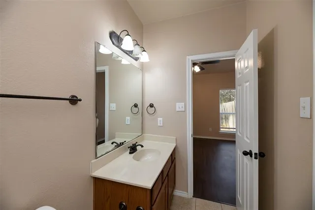 a bathroom with a sink a mirror and a shower