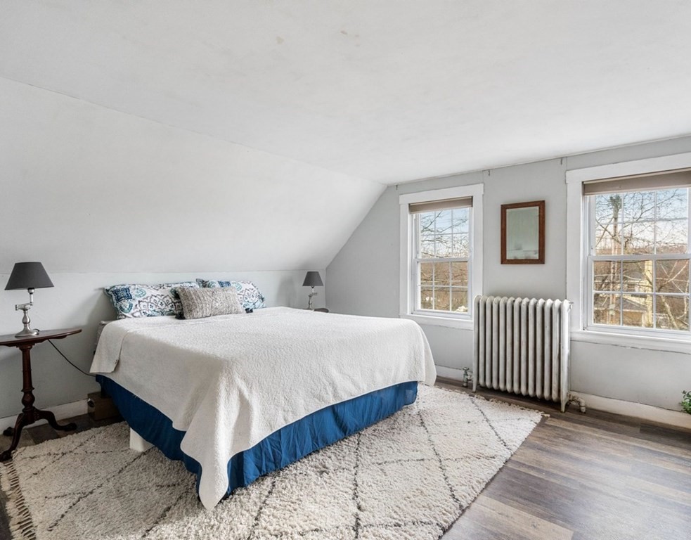 3 Upton Road Westborough, MA 01581 - Photo 19 of 34 a spacious bedroom with a bed a table and chair