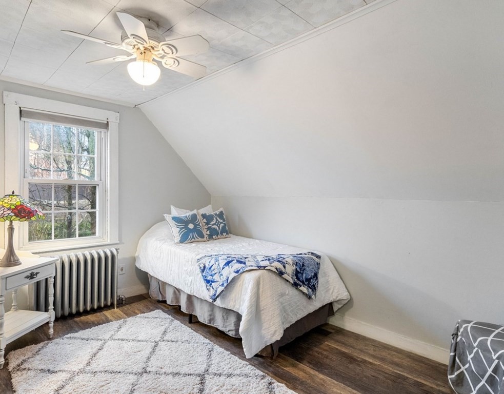 3 Upton Road Westborough, MA 01581 - Photo 20 of 34 a bedroom with a bed next to a window with a chandelier