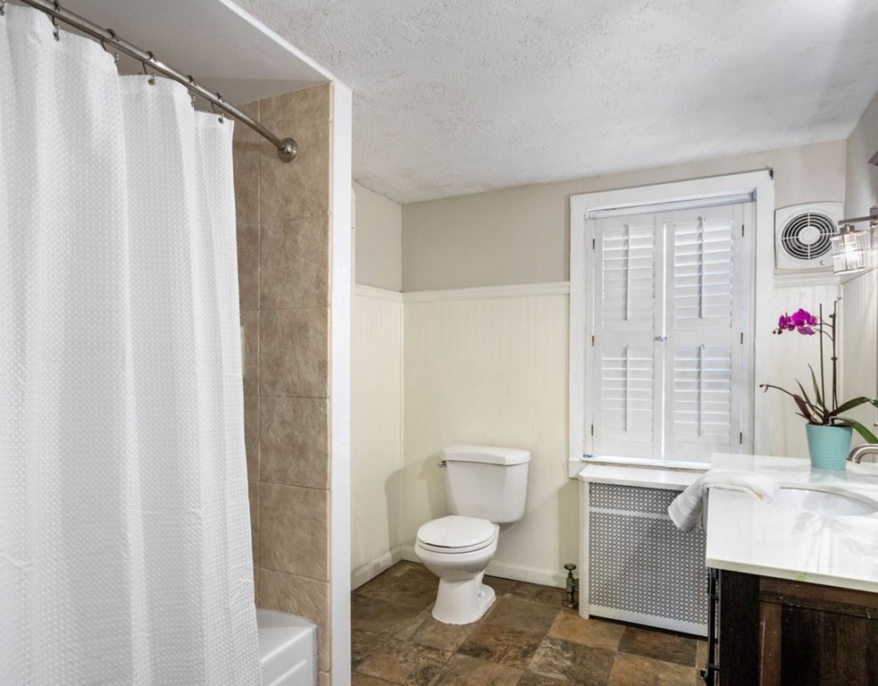 3 Upton Road Westborough, MA 01581 - Photo 21 of 34 a bathroom with a granite countertop sink toilet a mirror and shower