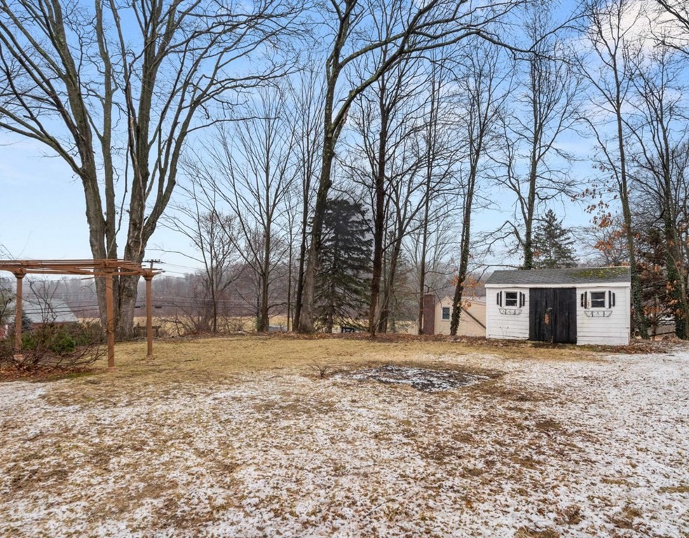 3 Upton Road Westborough, MA 01581 - Photo 28 of 34 a front view of a house with a yard covered with snow and trees