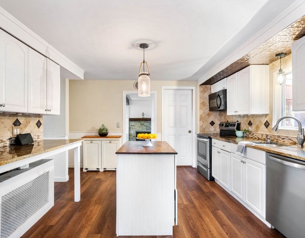 3 Upton Road Westborough, MA 01581 - Photo 9 of 34 a kitchen that has a lot of cabinets in it and appliances