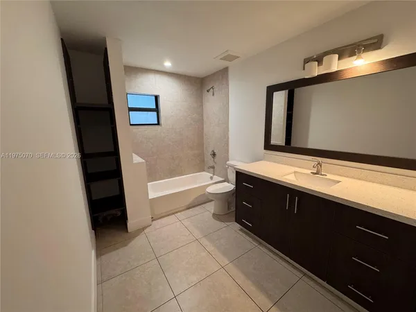 a bathroom with a double vanity sink and mirror
