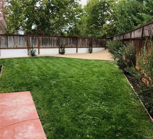 a swimming pool with wooden fence