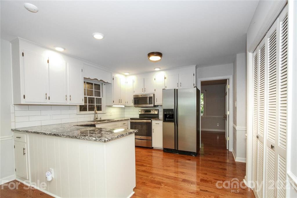 6204 Potter Road Matthews, NC 28104 - Photo 11 of 31 a kitchen with stainless steel appliances granite countertop a refrigerator and a stove top oven