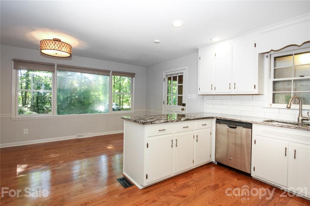 6204 Potter Road Matthews, NC 28104 - Photo 12 of 31 a kitchen with granite countertop a stove a sink and a large window