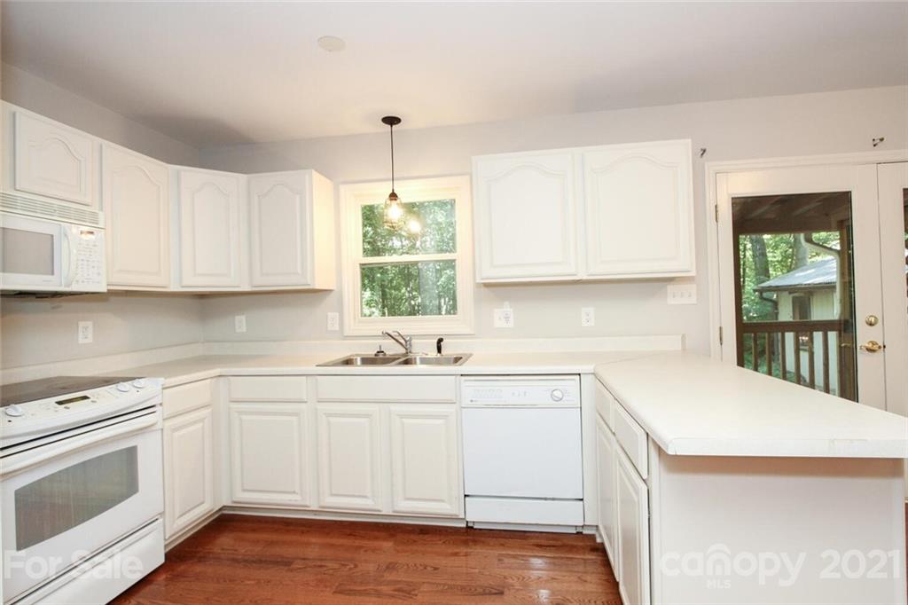 6204 Potter Road Matthews, NC 28104 - Photo 14 of 31 a kitchen with a sink stove and cabinets