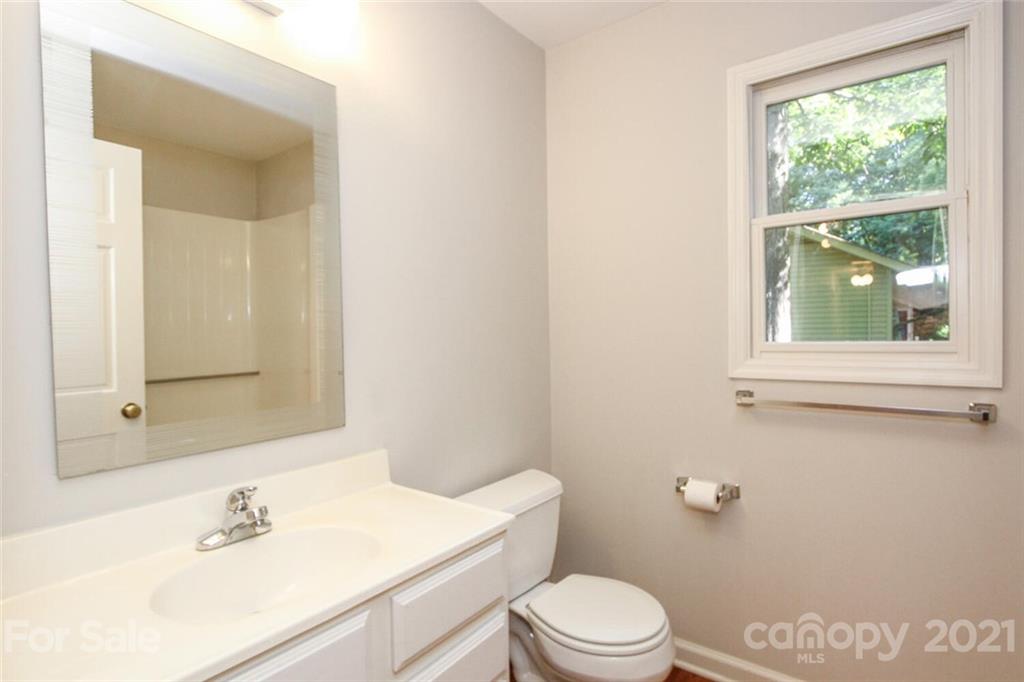 6204 Potter Road Matthews, NC 28104 - Photo 18 of 31 a bathroom with a sink a toilet and window