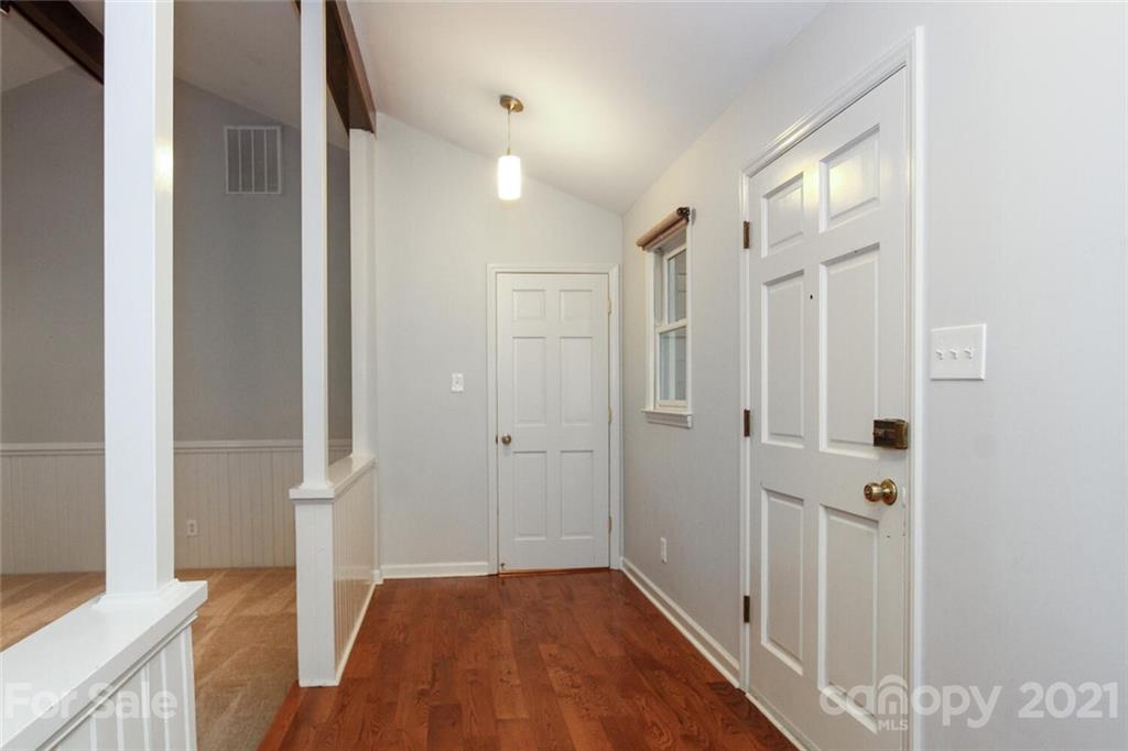 6204 Potter Road Matthews, NC 28104 - Photo 3 of 31 a view of a hallway with wooden floor and staircase