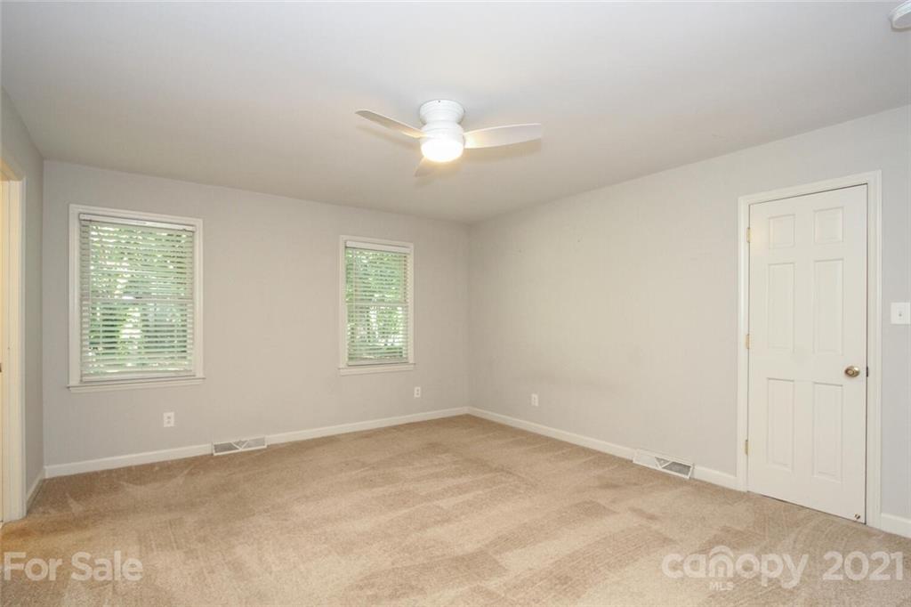 6204 Potter Road Matthews, NC 28104 - Photo 24 of 31 an empty room with chandelier fan and windows