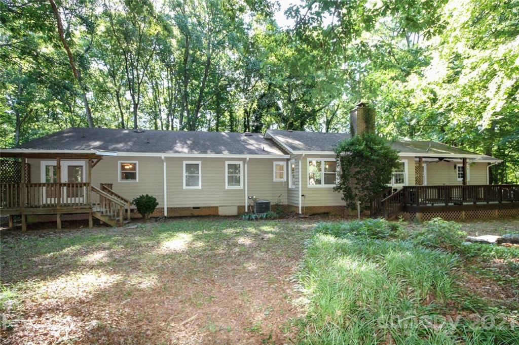 6204 Potter Road Matthews, NC 28104 - Photo 29 of 31 a view of a house with a yard
