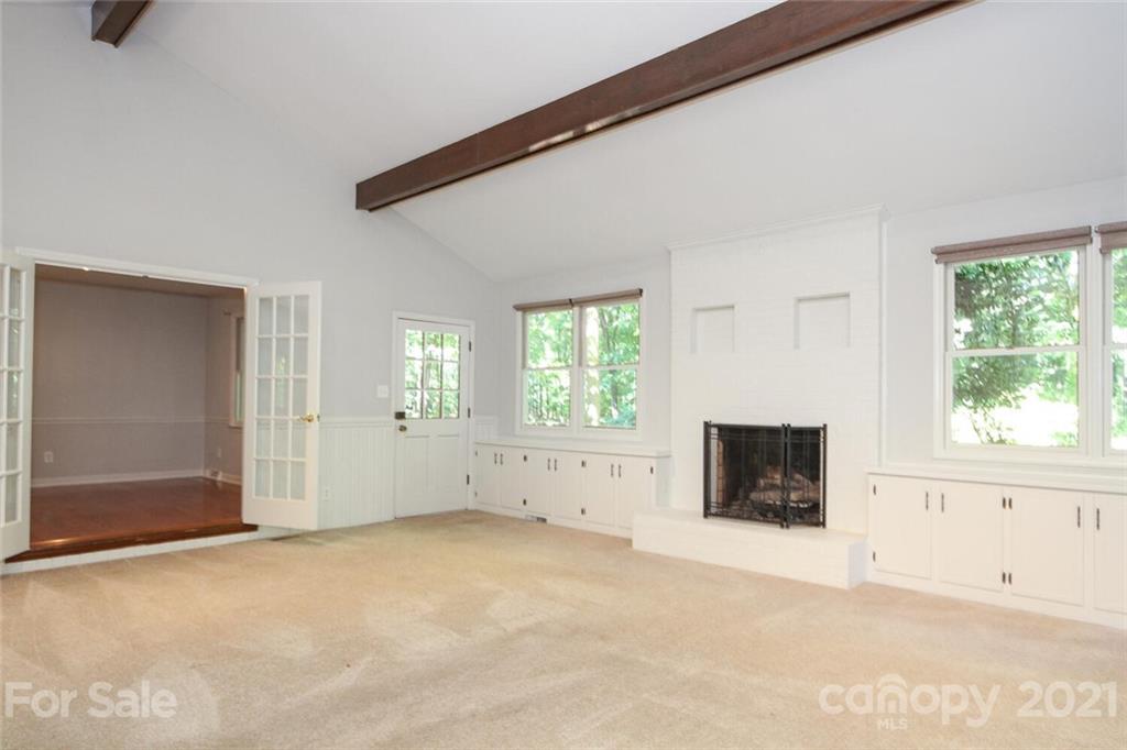 6204 Potter Road Matthews, NC 28104 - Photo 5 of 31 an empty room with windows and fireplace