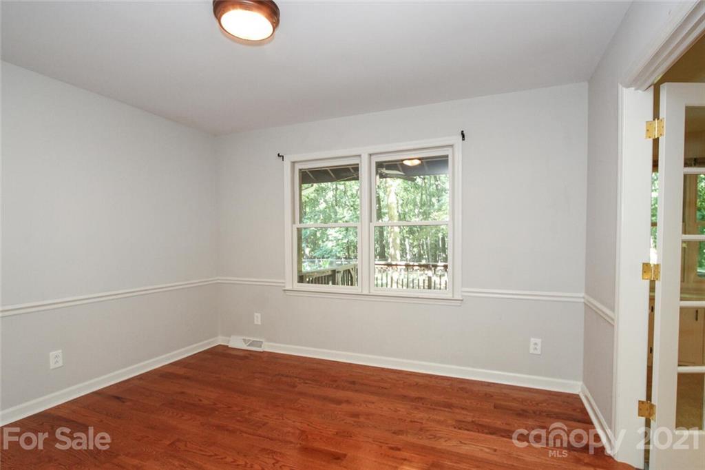 6204 Potter Road Matthews, NC 28104 - Photo 7 of 31 an empty room with wooden floor and windows