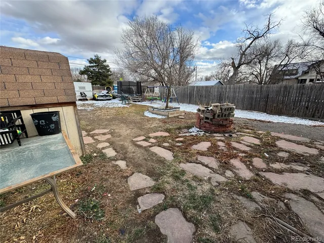 a view of a backyard with table and chairs