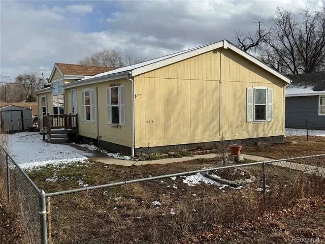 an empty room with wooden floor and fireplace