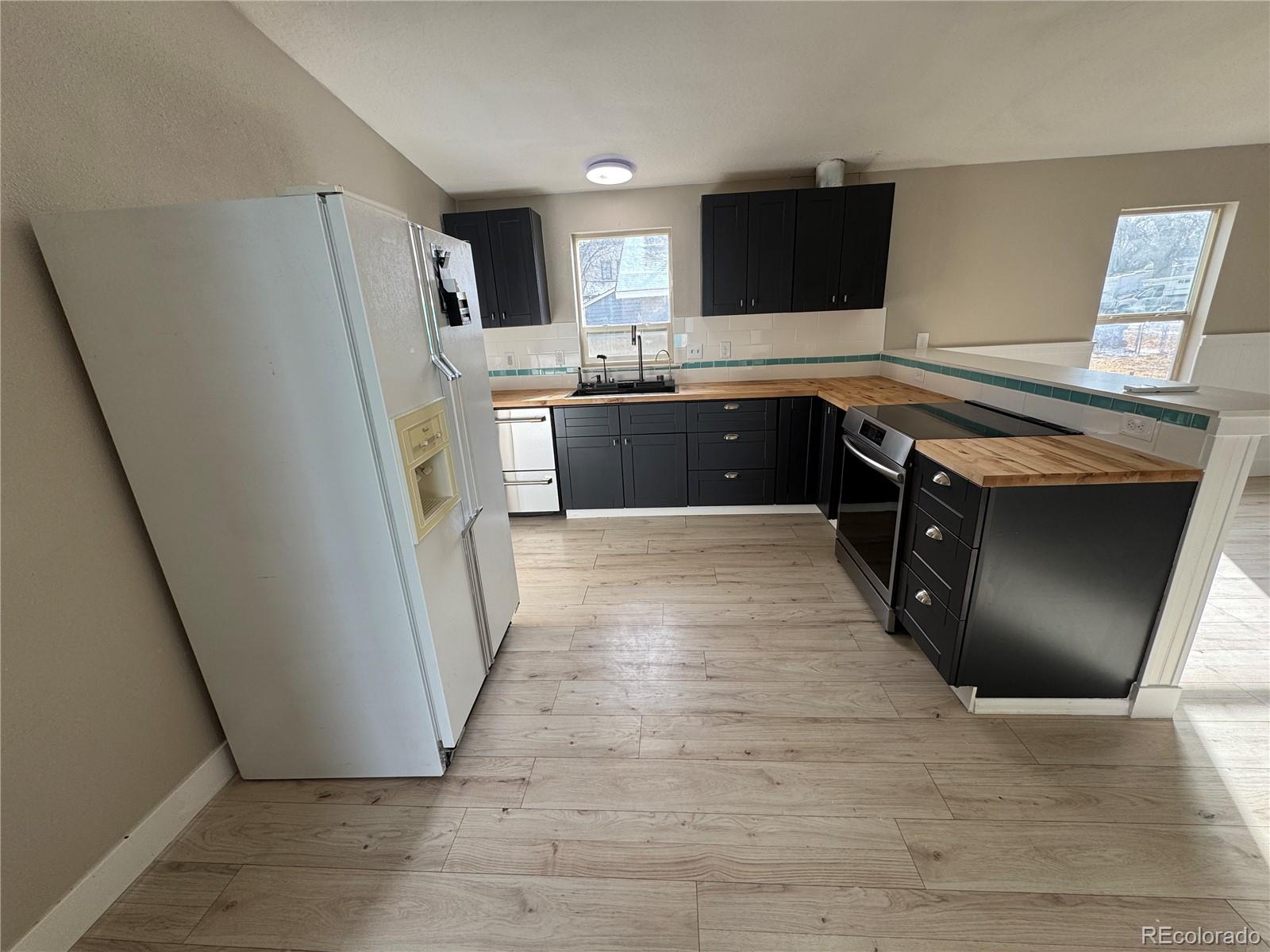 475 Pierce Street Erie, CO 80516 - Photo 4 of 16 a kitchen with stainless steel appliances granite countertop a sink stove and refrigerator