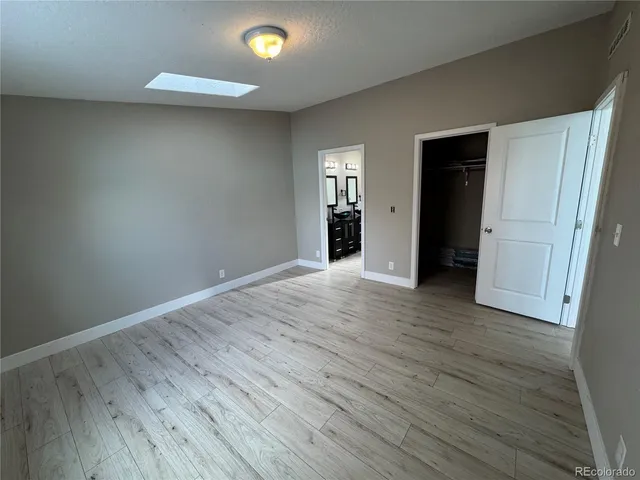 a living room with furniture and a mirror