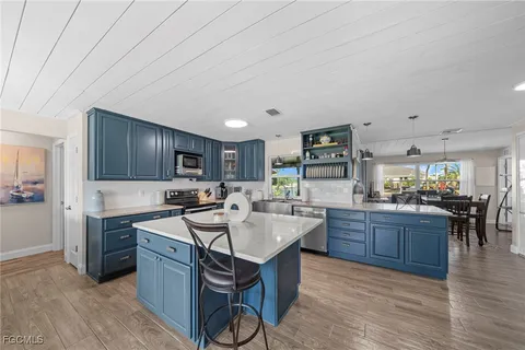 a kitchen with cabinets a sink and appliances