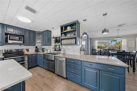 a kitchen with granite countertop stainless steel appliances and wooden cabinets