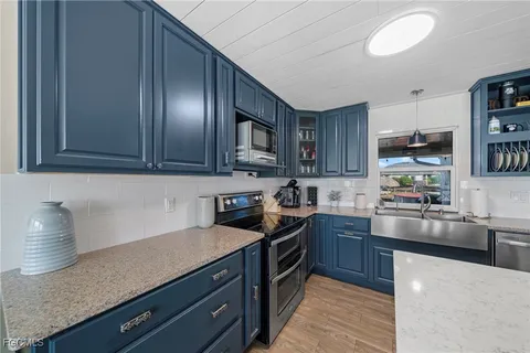 a kitchen with granite countertop stainless steel appliances and wooden cabinets