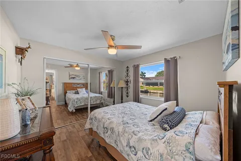 a bedroom that has a bed and a chandelier