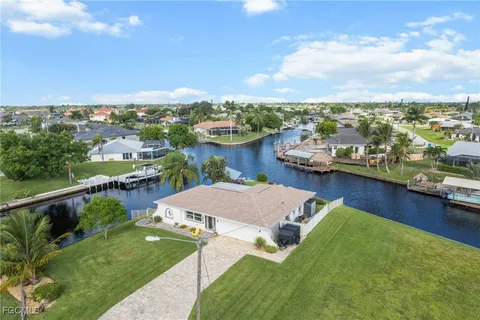 an aerial view of a house with garden space and ocean view