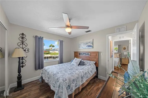 a bedroom with a large bed and a chandelier