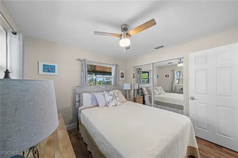 a bedroom with a large bed and a chandelier