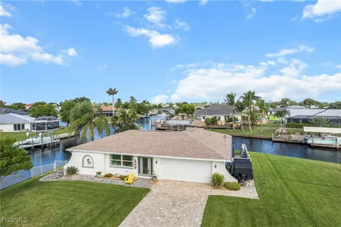 a aerial view of a house with swimming pool and furniture