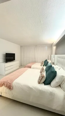 a bedroom with bed and a night stand