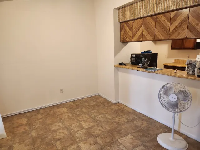 a kitchen with a sink a stove and a microwave