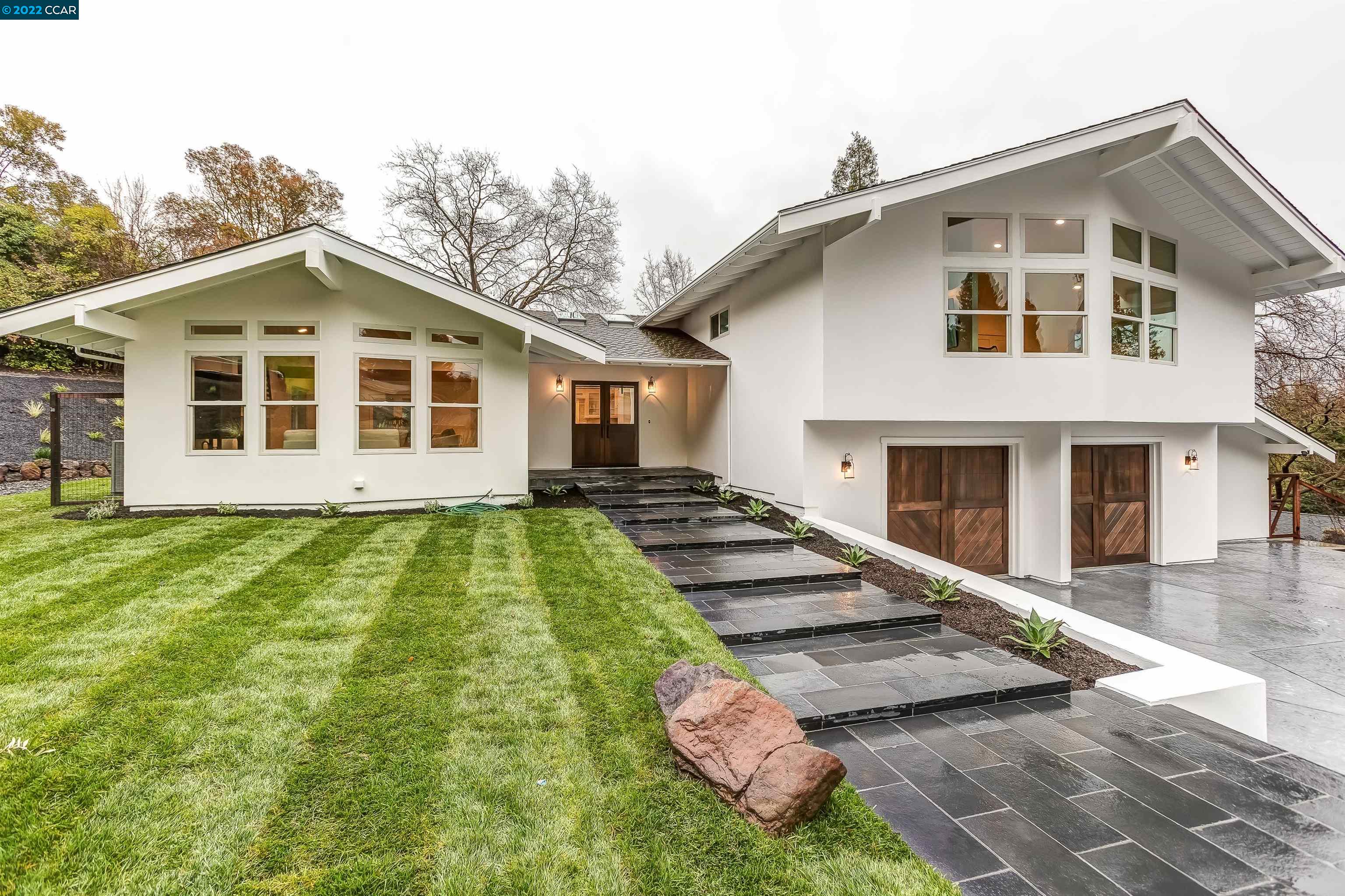 a front view of a house with garden