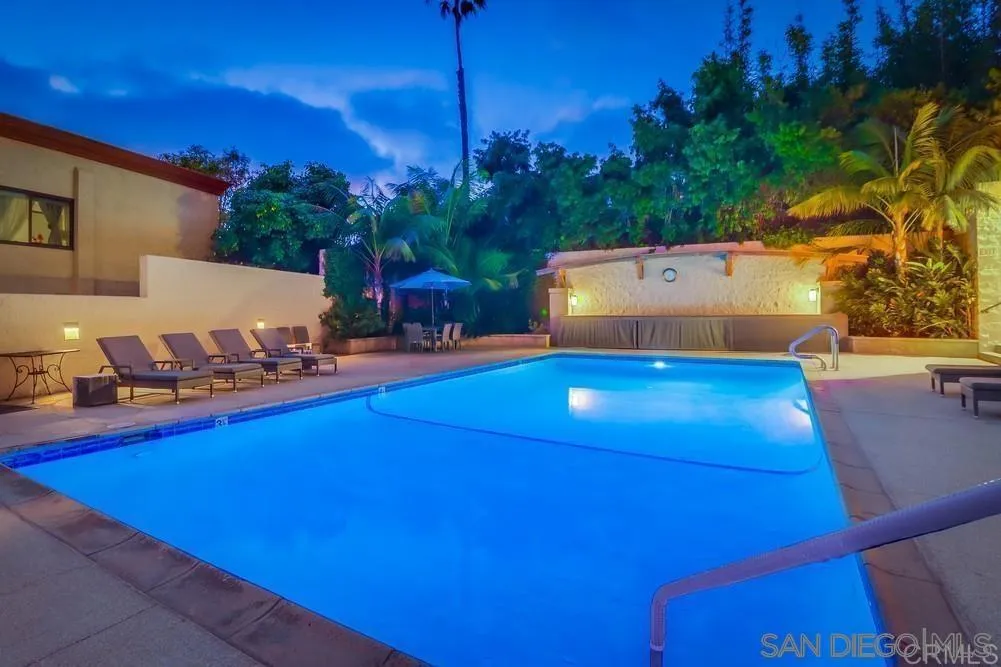 2500 Torrey Pines Road, Unit 402 La Jolla, CA 92037 - Photo 18 of 21 a view of a swimming pool with an outdoor seating and a yard