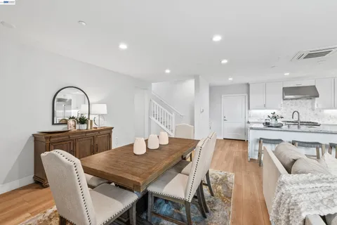 a living room with furniture a flat screen tv and a table