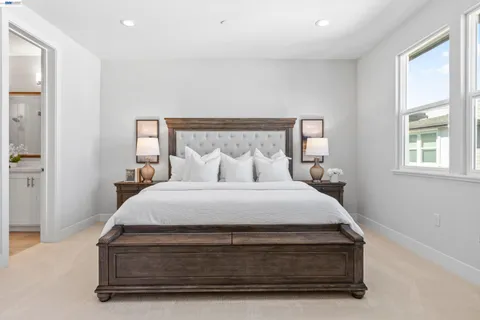 a spacious bedroom with a bed and furniture