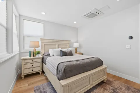 a spacious bathroom with a granite countertop sink a toilet and a mirror