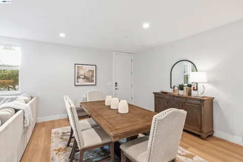 a living room with furniture a flat screen tv and a table