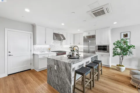 a kitchen with a sink stove and refrigerator